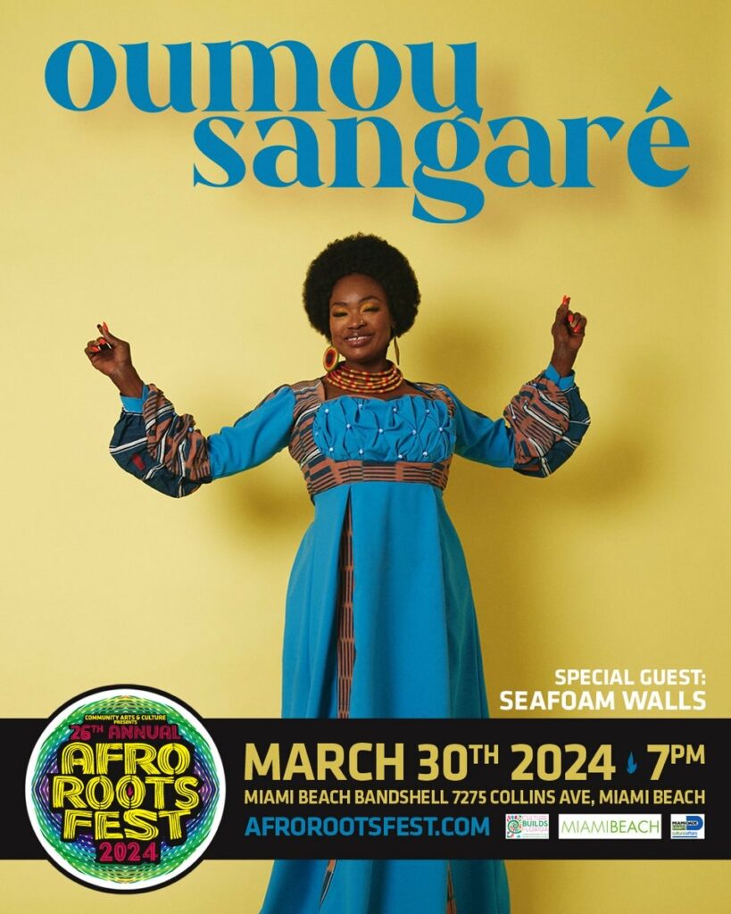 Oumou Sangare performing at Afro Roots Fest 2024 against a yellow background, Miami Beach event details below. WDNA 88.9FM Serious Jazz Community Public Radio supports Afro Roots Fest. Tune in to Afropop Worldwide on 88.9FM on Saturdays from 3PM to 4PM to hear more from Oumou Sangare.