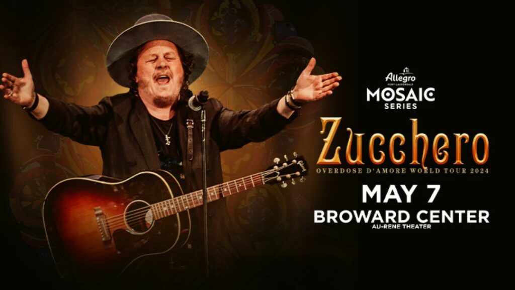 Zucchero on stage with a guitar, announcing his Overdose D'Amore World Tour 2024 at the Broward Center on May 7, part of the Allegro Fort Lauderdale Mosaic Series.
