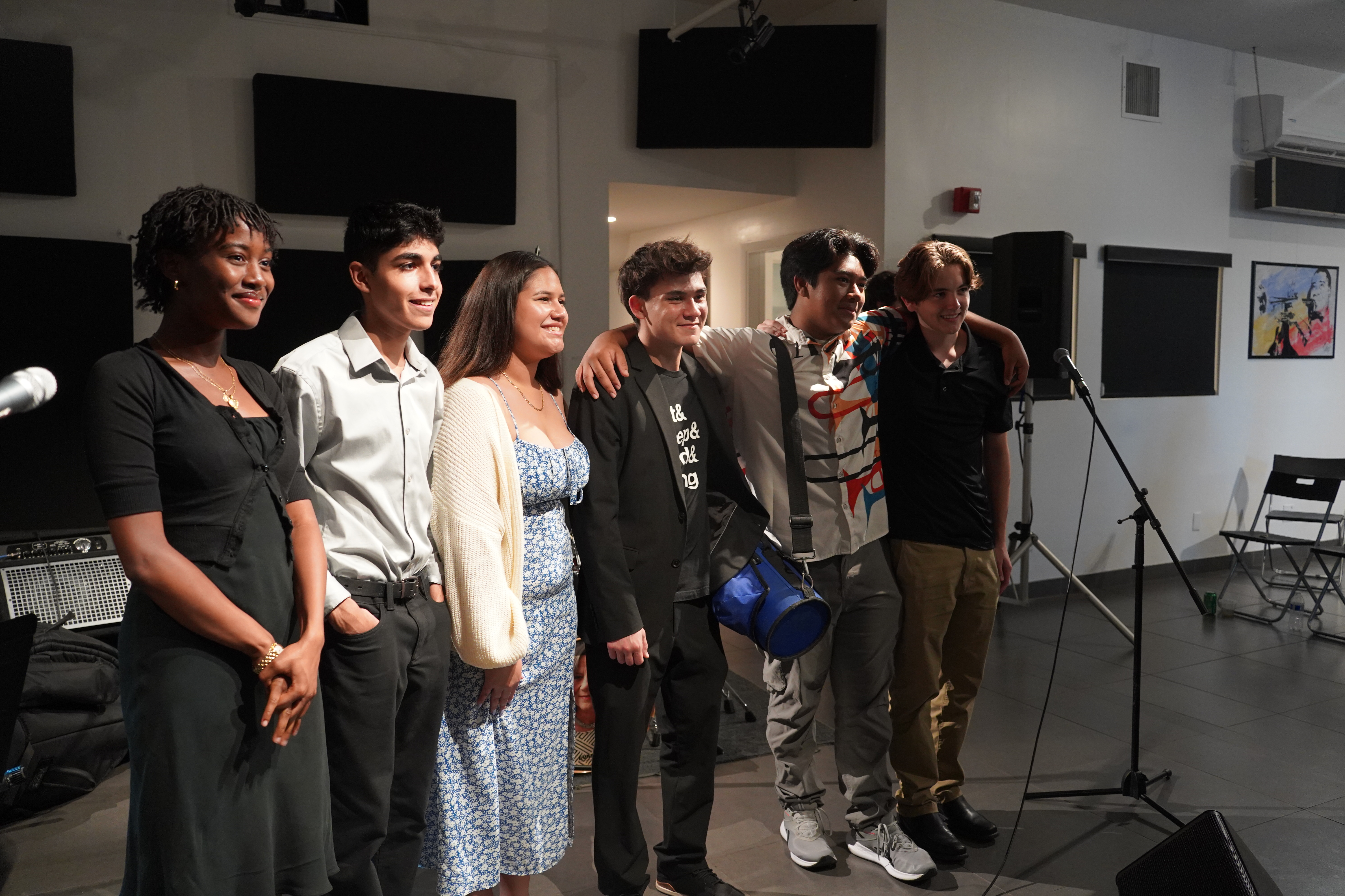 Group photo of 2024 WDNA music scholarship winners smiling at Jazz Gallery event, Miami.
