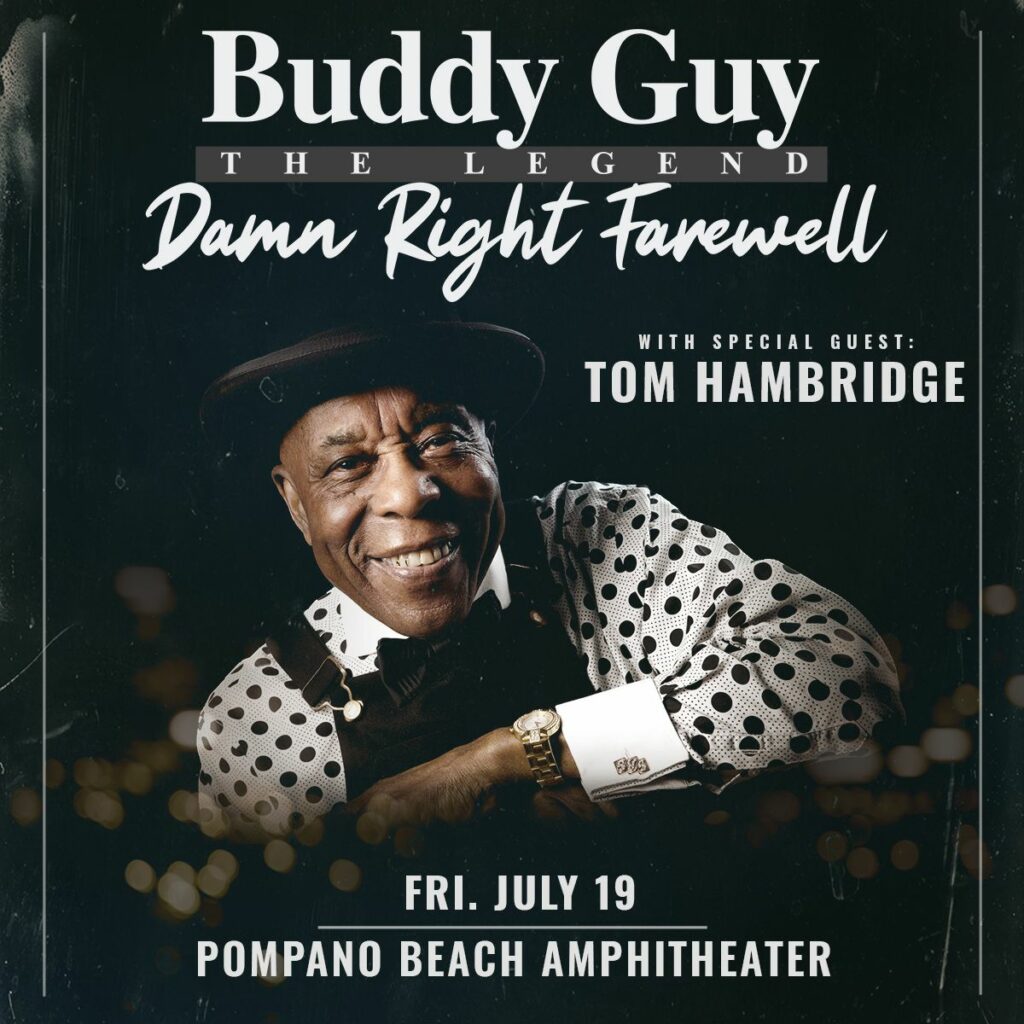 Buddy Guy smiling in a black and white polka dot shirt with Tom Hambridge as special guest for the Damn Right Farewell Tour at Pompano Beach Amphitheater.
