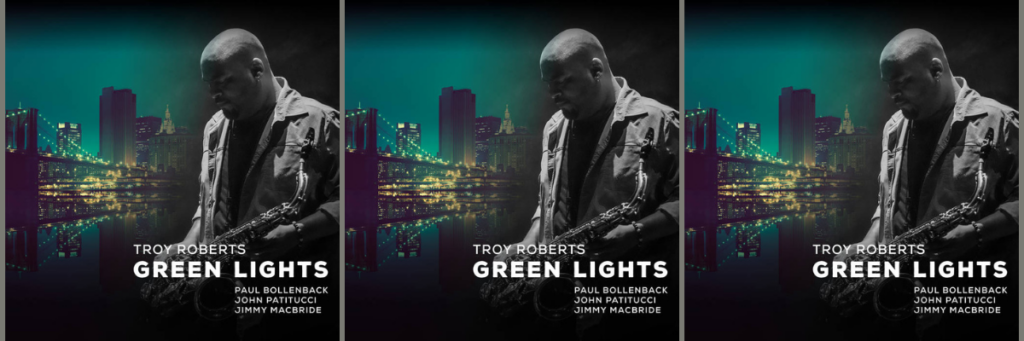 Troy Roberts' Green Lights album cover featuring a saxophonist in front of a city skyline, with featured artists Paul Bollenback, John Patitucci, and Jimmy Macbride. Listen now for a modern jazz masterpiece. WDNA 88.9FM's Jazz Album of the Week.